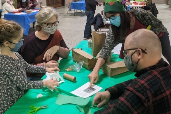 Adults and Children working together on a craft project