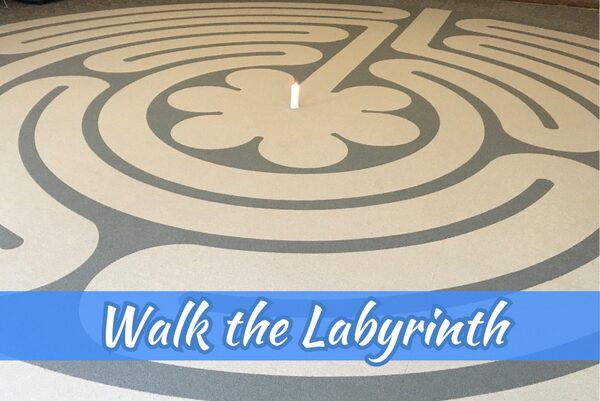 Indoor prayer labyrinth walking path with candle at the center